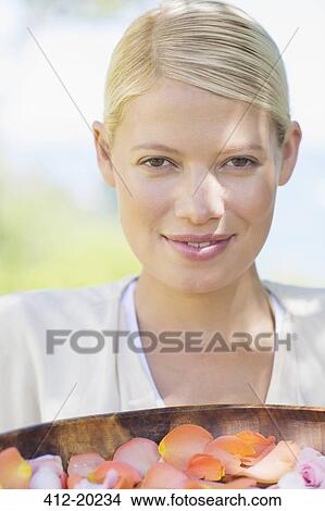 Woman carrying bowl of flower petals View Large Photo Image Picture - Woman carrying bowl of flower petals. Fotosearch