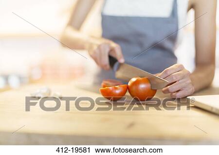 Woman chopping vegetables in kitchen View Large Photo Image Stock Image - Woman chopping vegetables in kitchen. Fotosearch