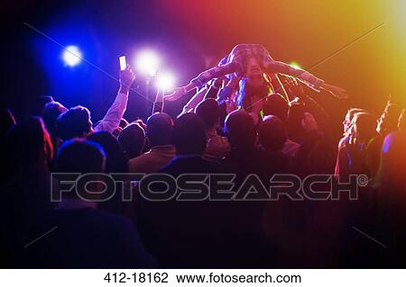 Woman crowd surfing at concert View Large Photo Image Stock Image - Woman crowd surfing at concert. Fotosearch