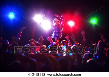 Woman dancing at concert View Large Photo Image Stock Image - Woman dancing at concert. Fotosearch