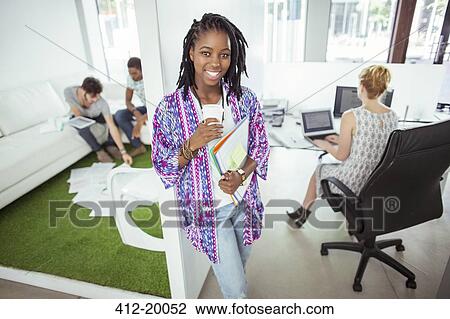 Woman drinking coffee in office View Large Photo Image Stock Image - Woman drinking coffee in office. Fotosearch