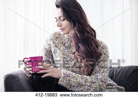 Woman drinking coffee on sofa View Large Photo Image Stock Image - Woman drinking coffee on sofa. Fotosearch