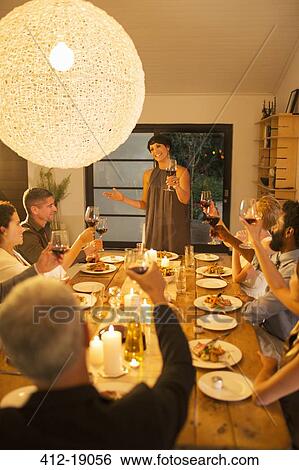 Woman giving toast at dinner party View Large Photo Image Stock Photograph - Woman giving toast at dinner party. Fotosearch