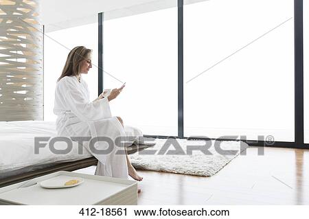 Woman having breakfast on bed View Large Photo Image Stock Image - Woman having breakfast on bed. Fotosearch