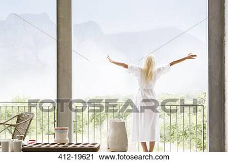 Woman in bathrobe overlooking landscape View Large Photo Image Stock Image - Woman in bathrobe overlooking landscape. Fotosearch