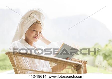Woman in bathrobe reading outdoors View Large Photo Image Picture - Woman in bathrobe reading outdoors. Fotosearch