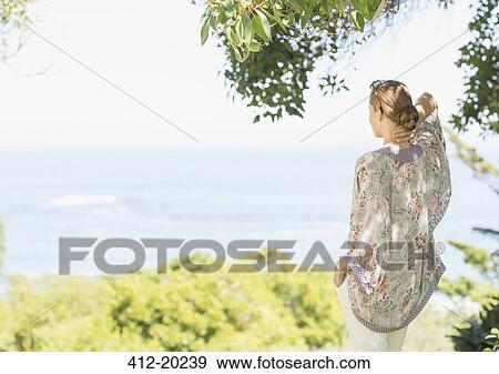 Stock Photo - Woman overlooking rural landscape. Fotosearch