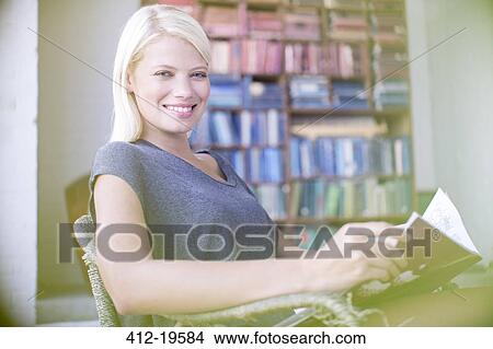 Woman reading in armchair View Large Photo Image Picture - Woman reading in armchair. Fotosearch