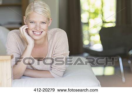 Woman relaxing on sofa View Large Photo Image Stock Photo - Woman relaxing on sofa. Fotosearch