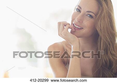 Woman resting chin in hand View Large Photo Image Stock Photo - Woman resting chin in hand. Fotosearch