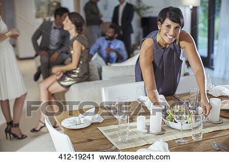 Woman serving food at dinner party View Large Photo Image Stock Image - Woman serving food at dinner party. Fotosearch