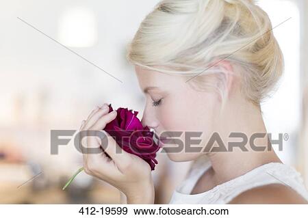 Stock Photo - Woman smelling rose. Fotosearch