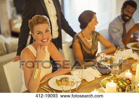 Woman smiling at dinner party View Large Photo Image Stock Image - Woman smiling at dinner party. Fotosearch