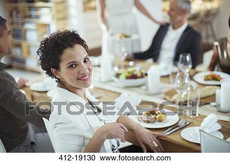 Woman smiling at dinner party View Large Photo Image Stock Image - Woman smiling at dinner party. Fotosearch