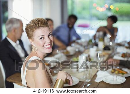 Woman smiling at dinner party View Large Photo Image Stock Photograph - Woman smiling at dinner party. Fotosearch