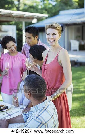 Woman smiling at party outdoors View Large Photo Image Stock Photo - Woman smiling at party outdoors. Fotosearch