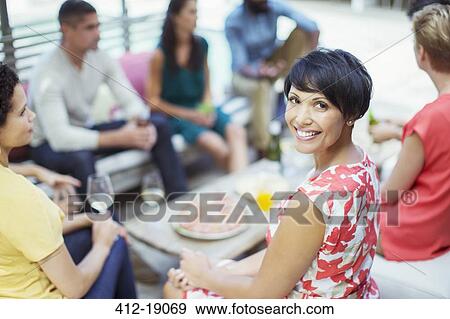 Woman smiling at party View Large Photo Image Stock Photo - Woman smiling at party. Fotosearch