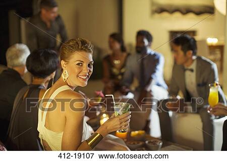 Woman smiling at party View Large Photo Image Stock Photo - Woman smiling at party. Fotosearch