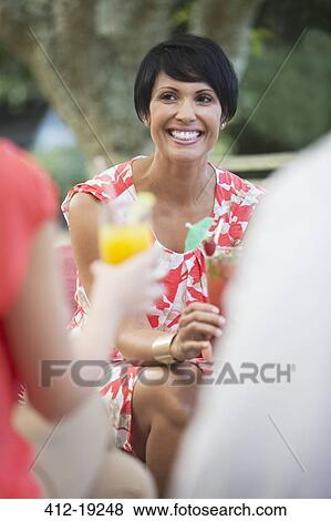 Woman smiling at party View Large Photo Image Stock Photo - Woman smiling at party. Fotosearch
