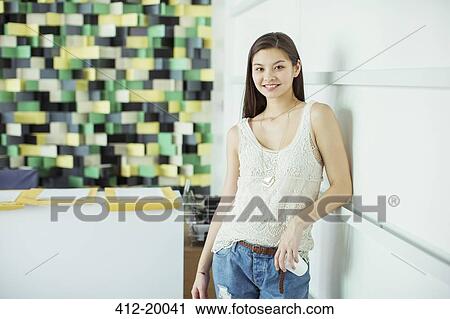 Stock Image - Woman smiling in office. Fotosearch