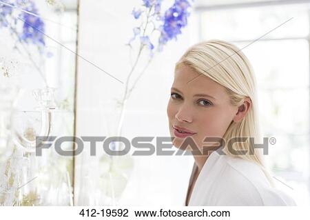 Woman standing at bathroom mirror View Large Photo Image Stock Image - Woman standing at bathroom mirror. Fotosearch