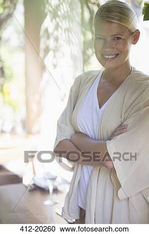Stock Image - Woman standing with arms crossed. Fotosearch
