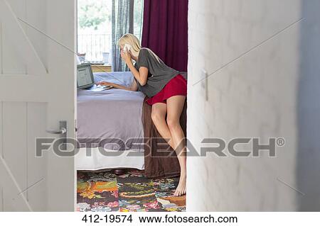 Woman talking on cell phone in bedroom View Large Photo Image Picture - Woman talking on cell phone in bedroom. Fotosearch