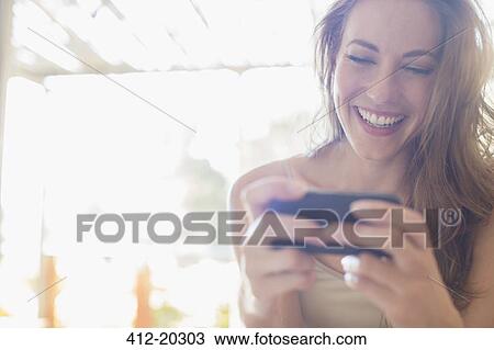 Woman using cell phone View Large Photo Image Stock Image - Woman using cell phone. Fotosearch