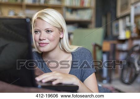 Woman using laptop in study View Large Photo Image Stock Photograph - Woman using laptop in study. Fotosearch