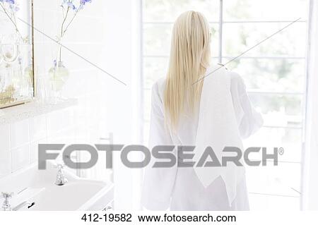 Woman wearing bathrobe in bathroom View Large Photo Image Stock Image - Woman wearing bathrobe in bathroom. Fotosearch