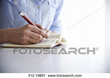 woman writing in notebook View Large Photo Image Stock Image - woman writing in notebook. Fotosearch
