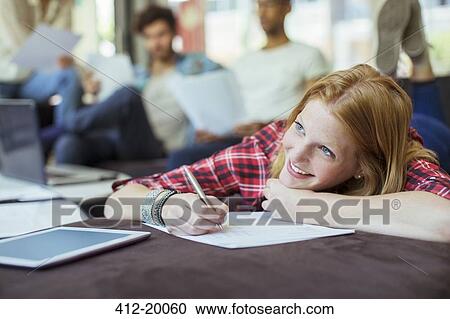 Woman writing in office View Large Photo Image Stock Image - Woman writing in office. Fotosearch