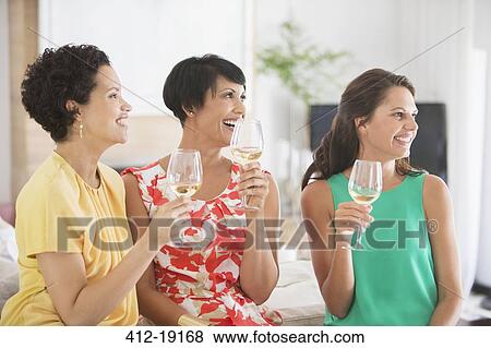 Stock Photo - Women drinking wine together. Fotosearch