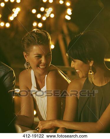 Women laughing at party View Large Photo Image Stock Image - Women laughing at party. Fotosearch
