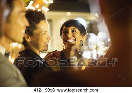 Stock Photo - Women laughing at party. Fotosearch