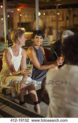 Women relaxing at party View Large Photo Image Stock Image - Women relaxing at party. Fotosearch
