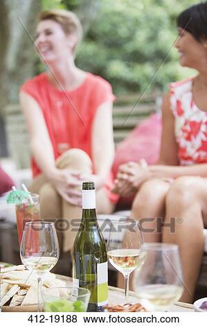 Women relaxing together at party View Large Photo Image Stock Photo - Women relaxing together at party. Fotosearch