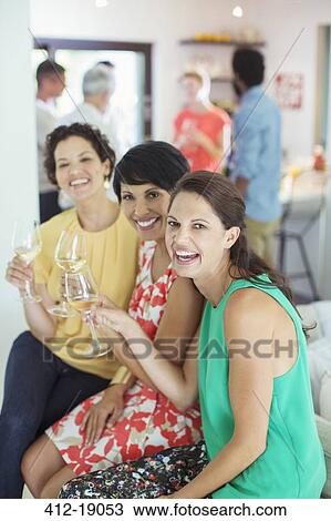Women smiling together at party View Large Photo Image Stock Image - Women smiling together at party. Fotosearch
