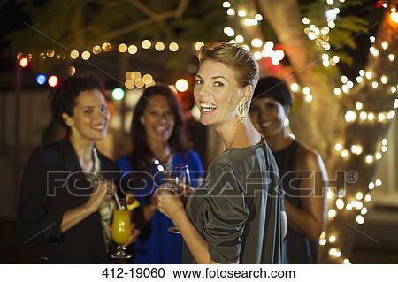 Stock Image - Women talking at party. Fotosearch