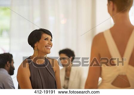Women talking at party View Large Photo Image Stock Image - Women talking at party. Fotosearch