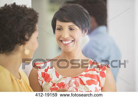 Women talking at party View Large Photo Image Stock Photo - Women talking at party. Fotosearch