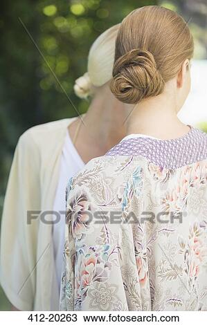 Stock Image - Women talking outdoors. Fotosearch