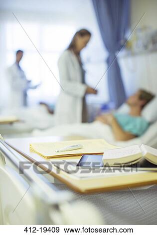 Close up of books on hospital bed tray View Large Photo Image Stock Photo - Close up of books on hospital bed tray. Fotosearch