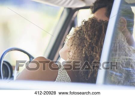 Stock Photo - Couple enjoying car ride on sunny day. Fotosearch