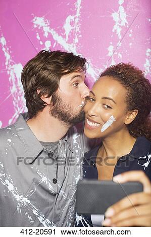 Couple playing and taking picture on cell phone View Large Photo Image Stock Image - Couple playing and taking picture on cell phone. Fotosearch