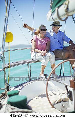 Couple sitting in boat together on water View Large Photo Image Stock Photo - Couple sitting in boat together on water . Fotosearch