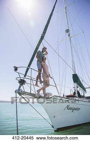 Couple standing on front of boat View Large Photo Image Stock Photography - Couple standing on front of boat. Fotosearch