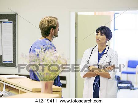 Doctor and nurse talking in hospital View Large Photo Image Stock Image - Doctor and nurse talking in hospital. Fotosearch