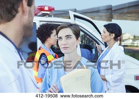 Doctor and nurse talking outside hospital View Large Photo Image Stock Photo - Doctor and nurse talking outside hospital. Fotosearch