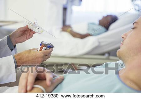 Doctor explaining medication to patient in hospital View Large Photo Image Stock Image - Doctor explaining medication to patient in hospital. Fotosearch
